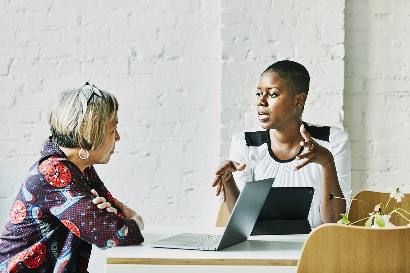 Female financial advisor in discussion with client in office conference room
